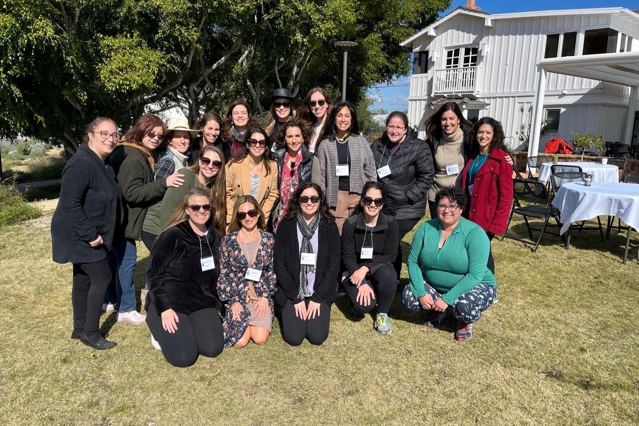 Cohort 3 of the Pauline Foster Women's Leadership Institute together outdoors during a program day