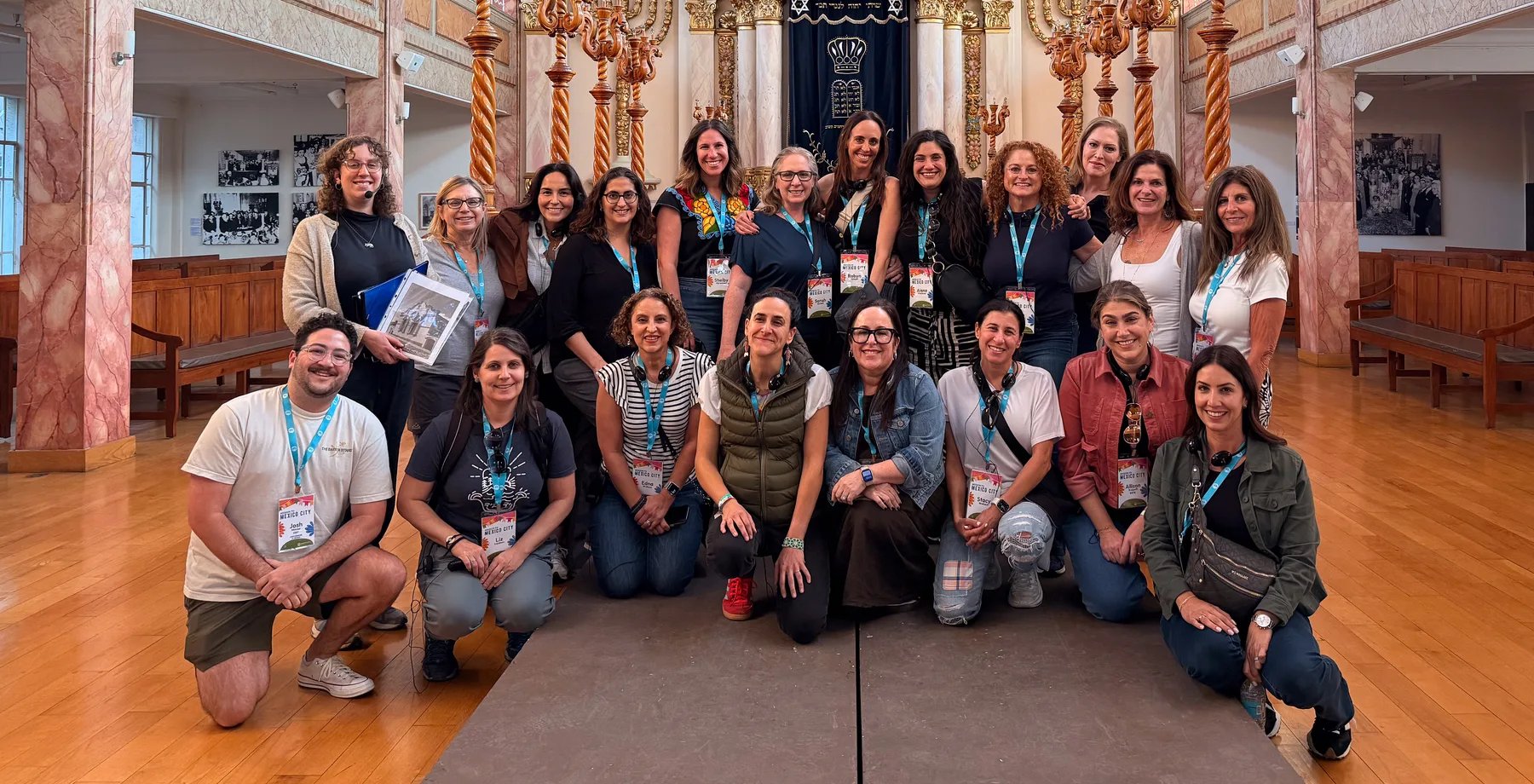 Institute participants together in front of the ark of a historic synagogue during the Mexico City cohort immersion